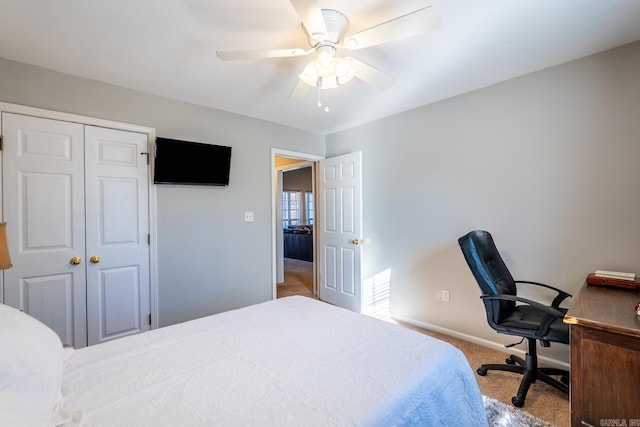 carpeted bedroom featuring a closet, a ceiling fan, and baseboards