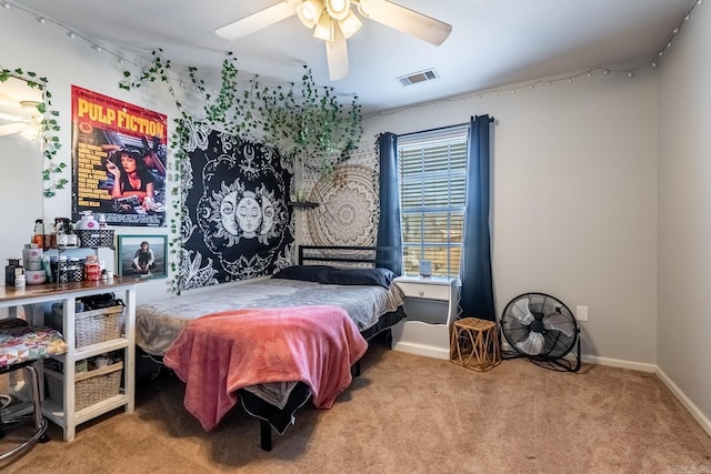 carpeted bedroom featuring baseboards, visible vents, and ceiling fan