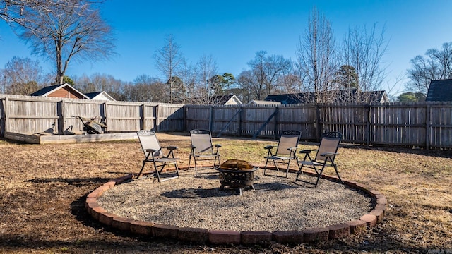 view of yard featuring a fire pit and a fenced backyard