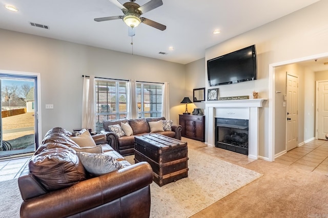 living area with recessed lighting, light colored carpet, a fireplace with flush hearth, a ceiling fan, and visible vents