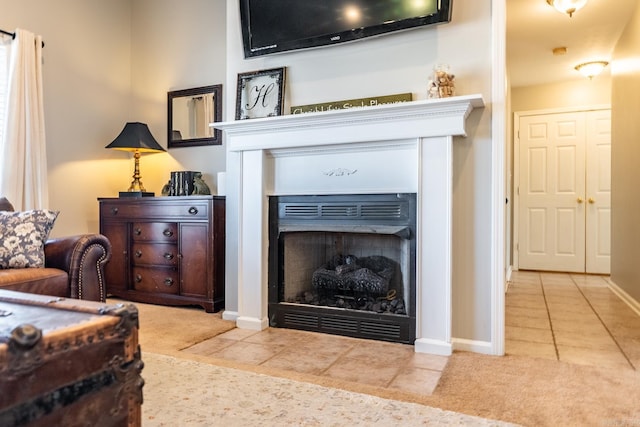 living area with light carpet, light tile patterned flooring, a fireplace with flush hearth, and baseboards