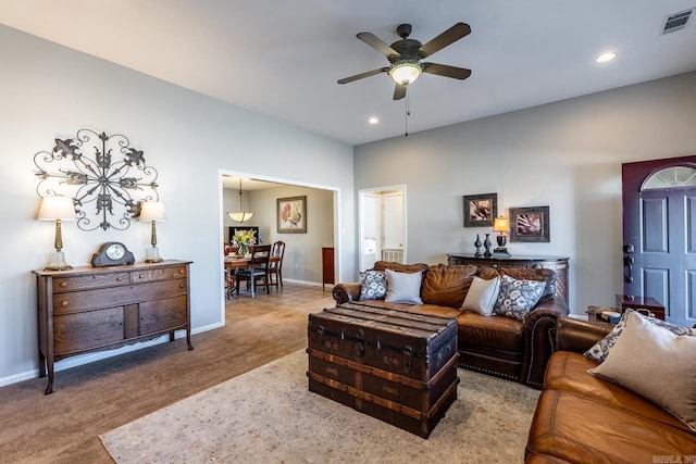 living room featuring light carpet, baseboards, visible vents, and a ceiling fan