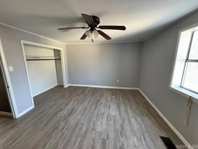 unfurnished bedroom with baseboards, wood finished floors, and ornamental molding