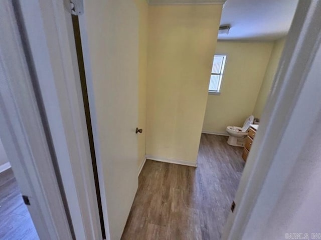 bathroom featuring toilet, baseboards, and wood finished floors