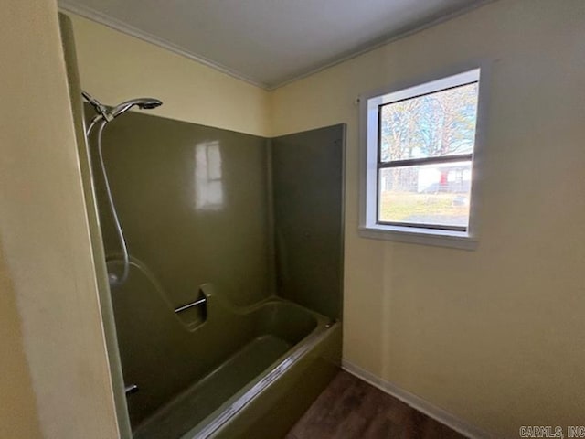 full bathroom featuring shower / washtub combination, baseboards, and wood finished floors