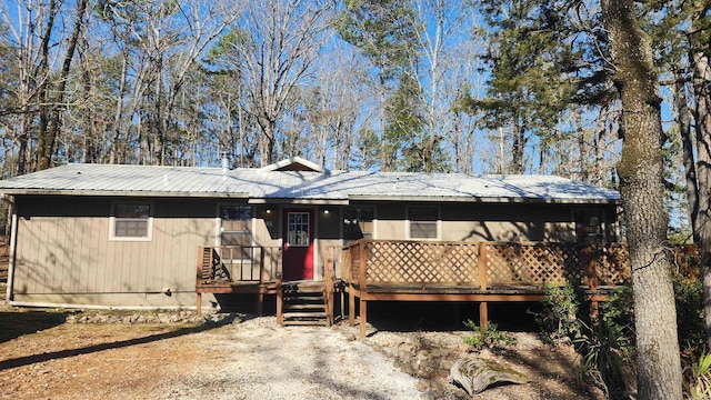 ranch-style home with crawl space, metal roof, and a deck