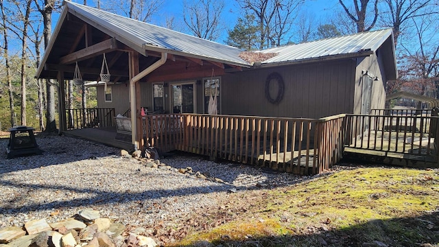 rustic home featuring metal roof and a deck