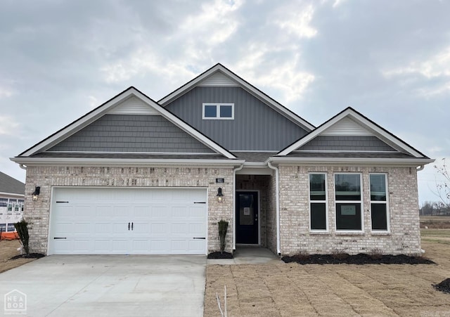 view of front of home with concrete driveway, brick siding, and an attached garage