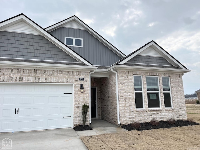 view of front of house featuring concrete driveway, brick siding, and an attached garage