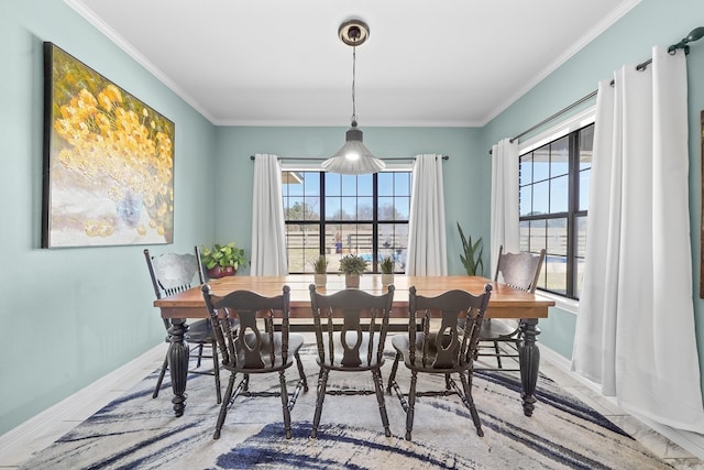 dining area with baseboards and ornamental molding