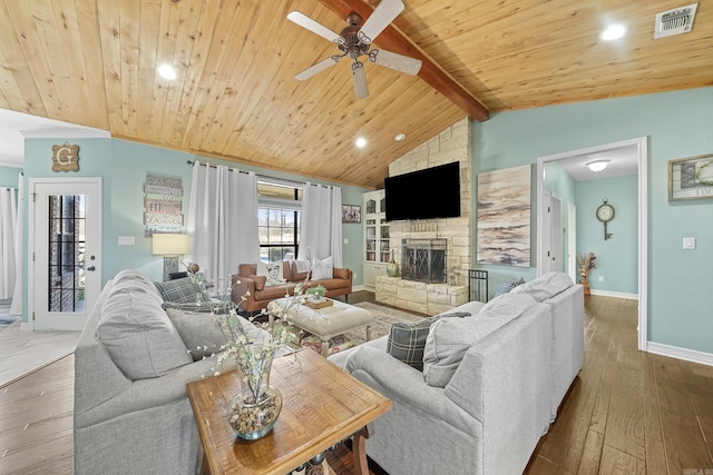 living room featuring vaulted ceiling with beams, wooden ceiling, a fireplace, and wood finished floors