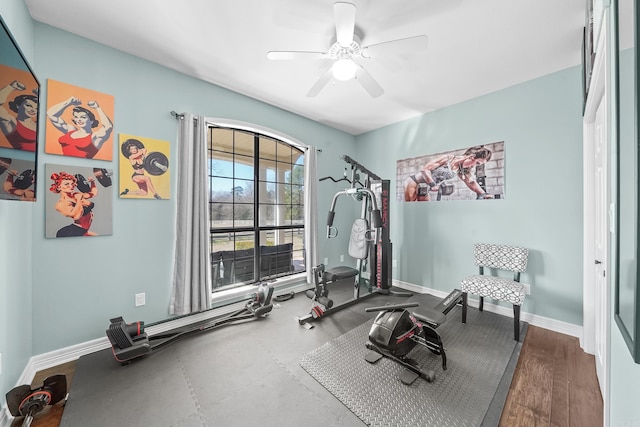 workout area featuring ceiling fan and baseboards