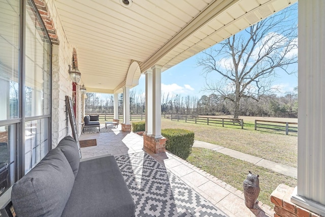 view of patio featuring fence and a rural view