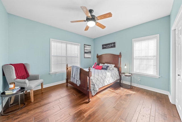 bedroom featuring ceiling fan, dark wood-type flooring, and baseboards