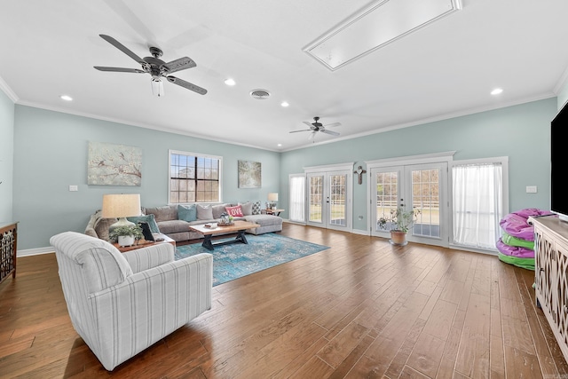 living area with dark wood-style flooring, visible vents, french doors, attic access, and crown molding