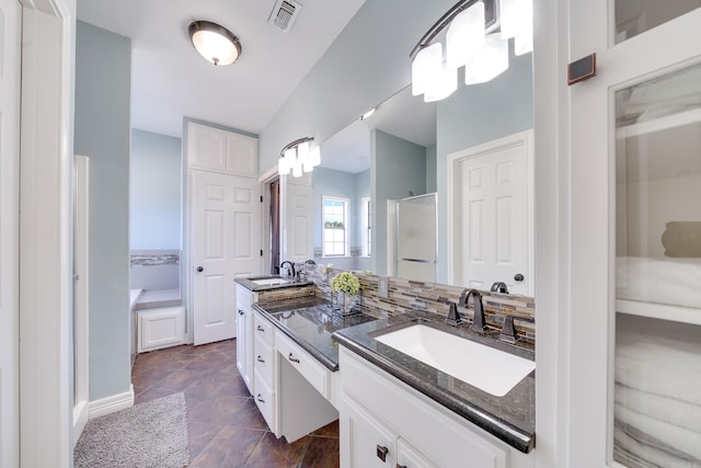 bathroom with visible vents, a sink, a shower stall, and double vanity