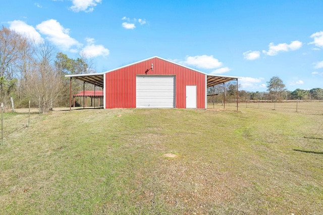 view of pole building with a rural view, a yard, and driveway