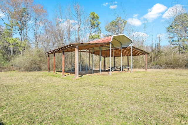 view of home's community with a carport and a lawn