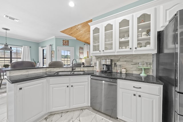 kitchen with visible vents, white cabinets, appliances with stainless steel finishes, a peninsula, and a sink