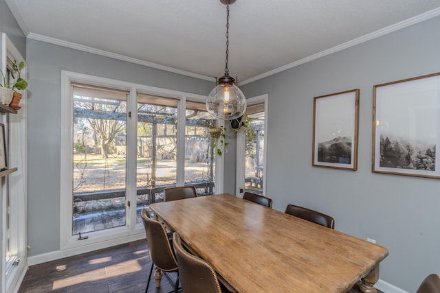 dining area featuring baseboards, ornamental molding, and dark wood finished floors