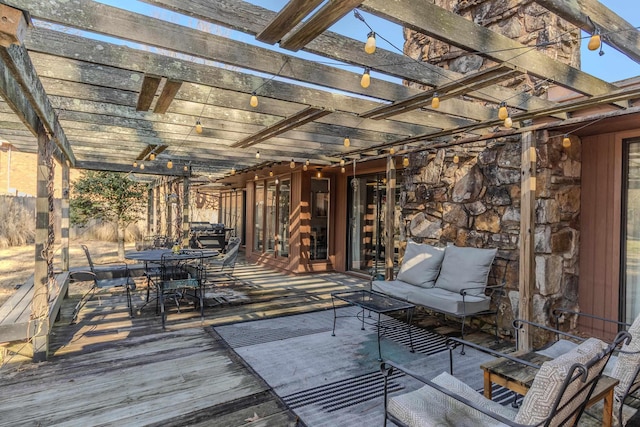 deck with an outdoor living space, outdoor dining space, and a pergola