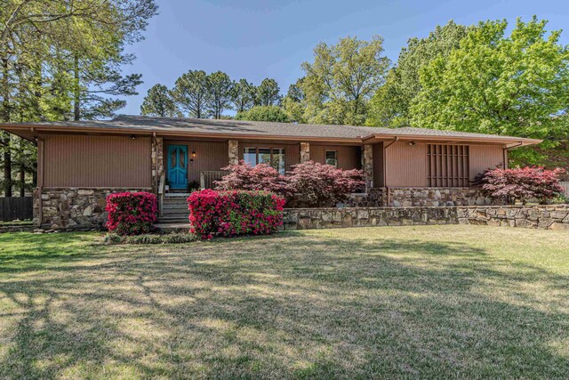 single story home with a front yard and stone siding