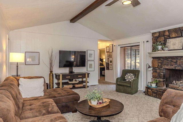 living area with a fireplace, carpet flooring, vaulted ceiling with beams, and ceiling fan