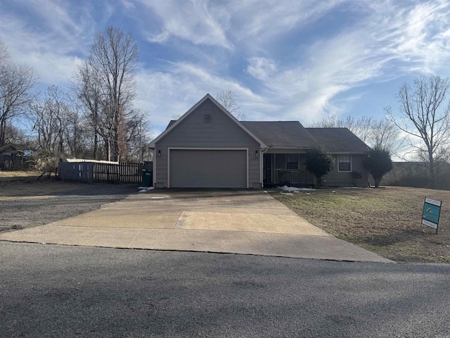 single story home with a garage and driveway