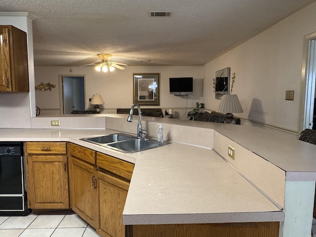 kitchen with a peninsula, visible vents, light countertops, and a sink