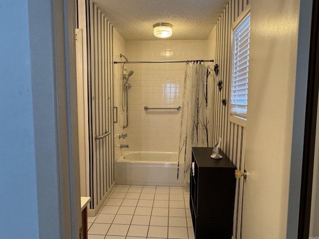 full bathroom featuring vanity, shower / tub combo with curtain, a textured ceiling, and tile patterned floors