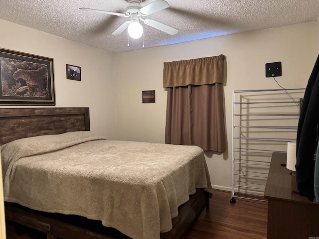 bedroom with ceiling fan, a textured ceiling, baseboards, and dark wood-style flooring