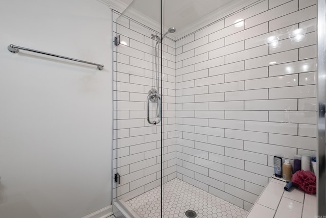 full bath with ornamental molding and a shower stall