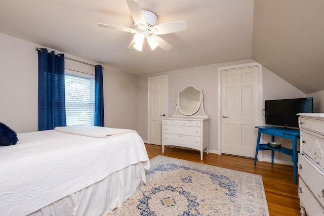 bedroom featuring lofted ceiling, ceiling fan, baseboards, and wood finished floors