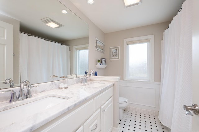 bathroom with plenty of natural light, a sink, and visible vents