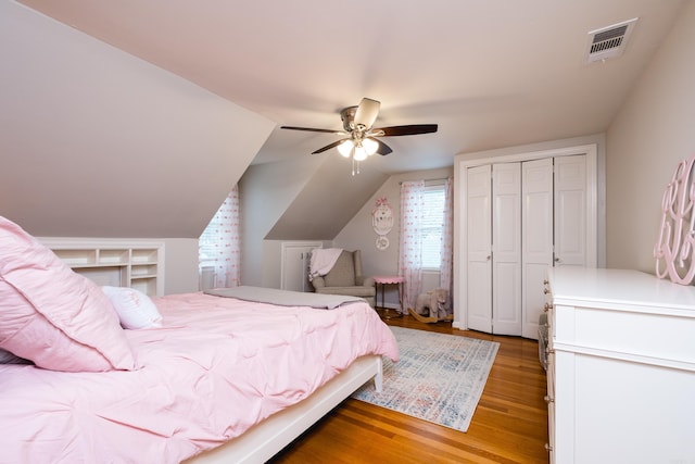 bedroom with lofted ceiling, ceiling fan, light wood-style flooring, visible vents, and a closet