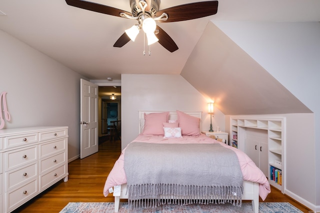 bedroom featuring a ceiling fan, vaulted ceiling, and wood finished floors