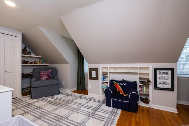 bedroom featuring vaulted ceiling, light wood-style flooring, and baseboards