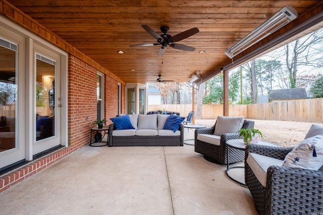 view of patio featuring fence, an outdoor living space, and ceiling fan