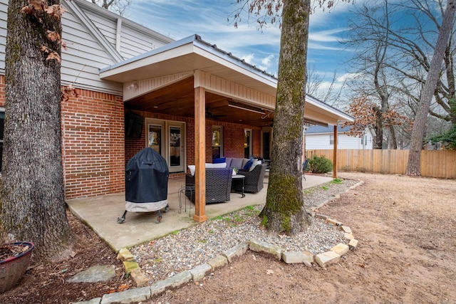 view of patio / terrace with french doors, fence, grilling area, and an outdoor hangout area