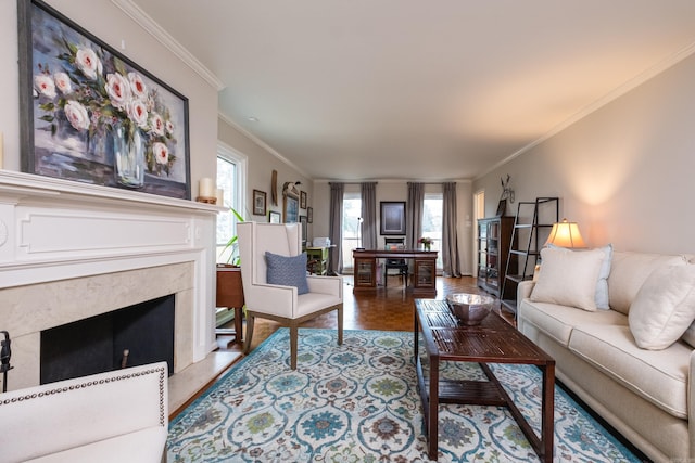 living area featuring ornamental molding, plenty of natural light, and a fireplace