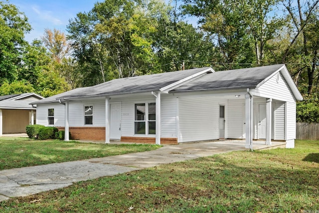 ranch-style house with concrete driveway, brick siding, and a front yard