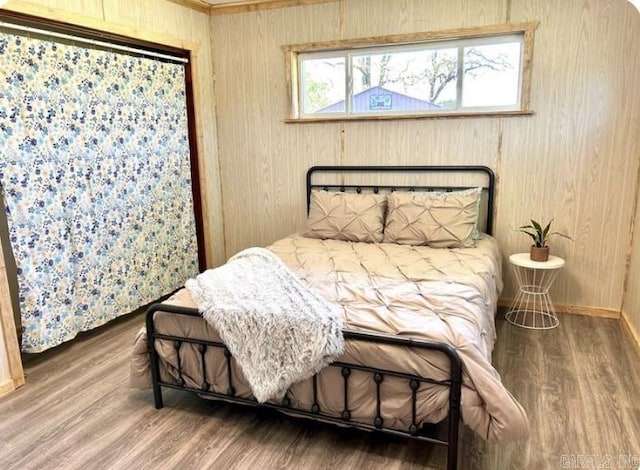 bedroom with wood finished floors and baseboards