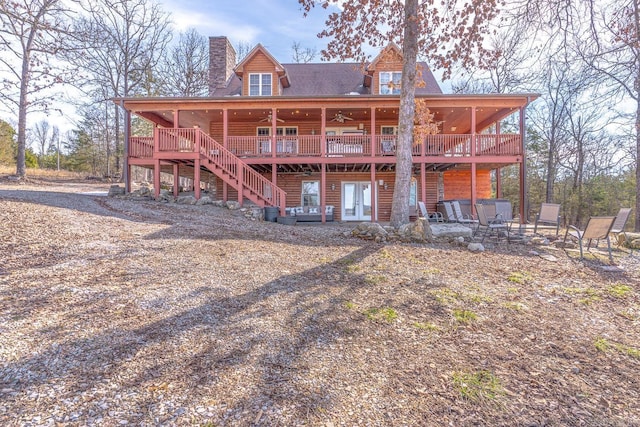 rear view of house with ceiling fan, a chimney, stairway, a wooden deck, and a patio area