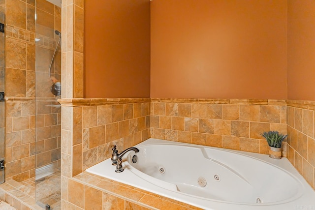 full bath featuring a jetted tub and a stall shower