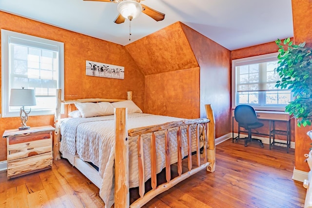 bedroom featuring ceiling fan, baseboards, and wood finished floors