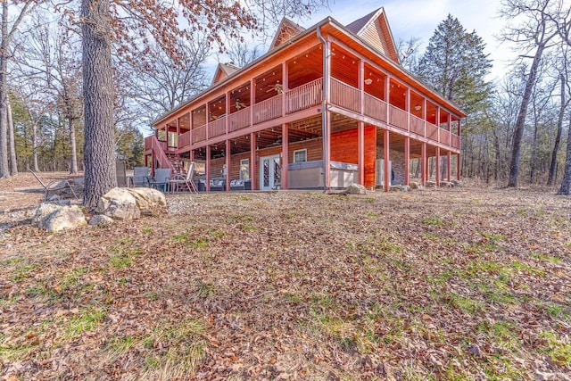 back of house featuring ceiling fan and a wooden deck