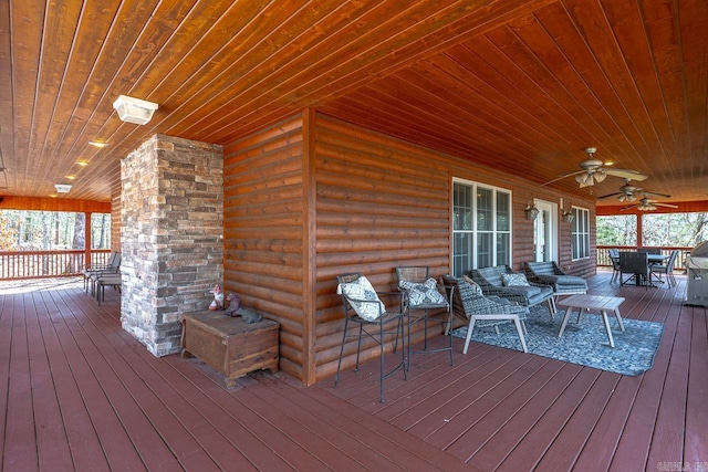 wooden terrace with outdoor dining space, ceiling fan, and an outdoor hangout area