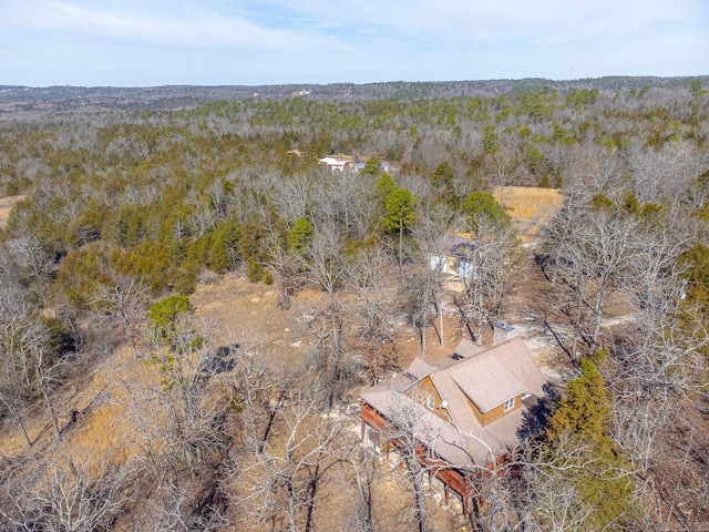 bird's eye view with a wooded view