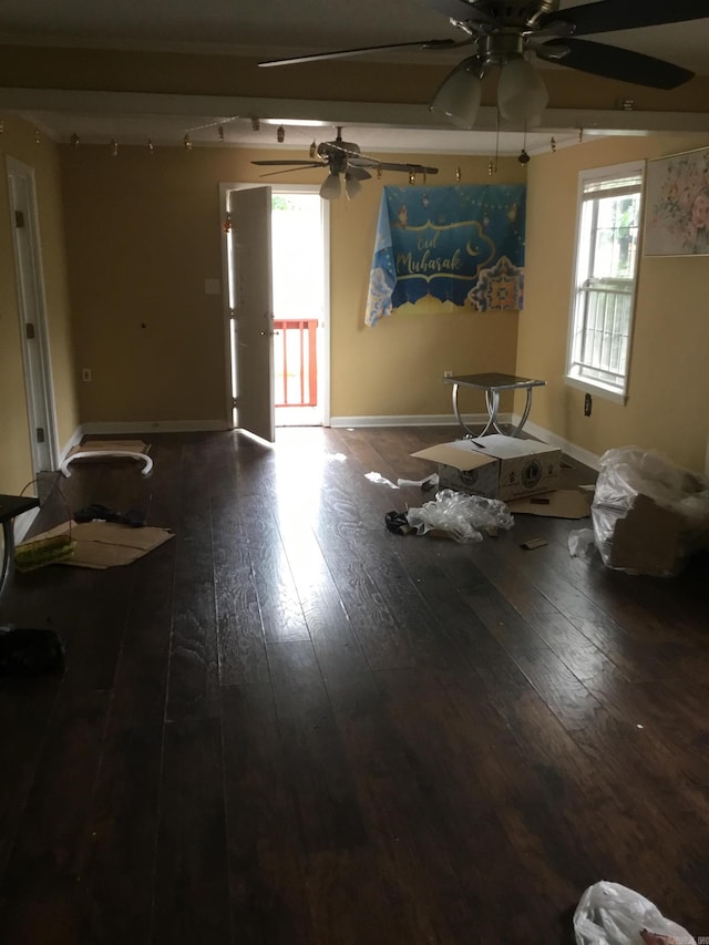 interior space with a ceiling fan, baseboards, track lighting, and hardwood / wood-style flooring