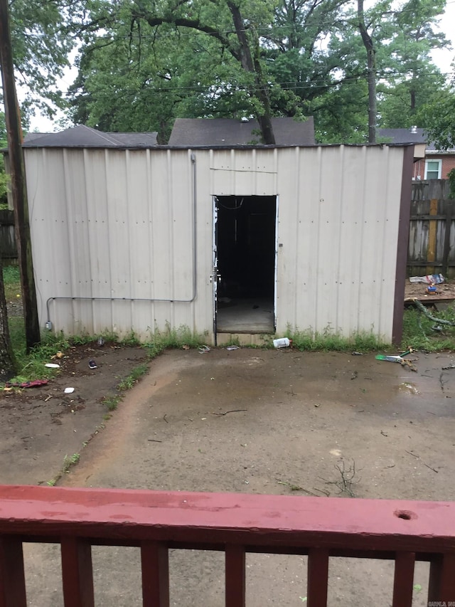 view of shed featuring fence